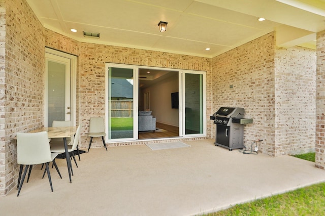 view of patio featuring visible vents and grilling area
