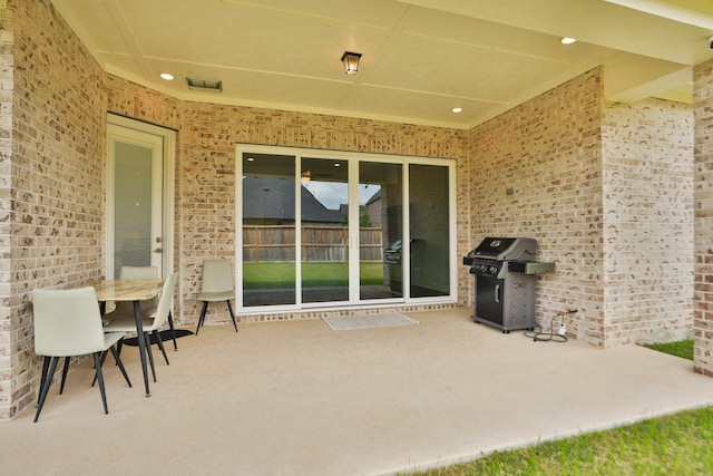view of patio with visible vents, outdoor dining space, and a grill
