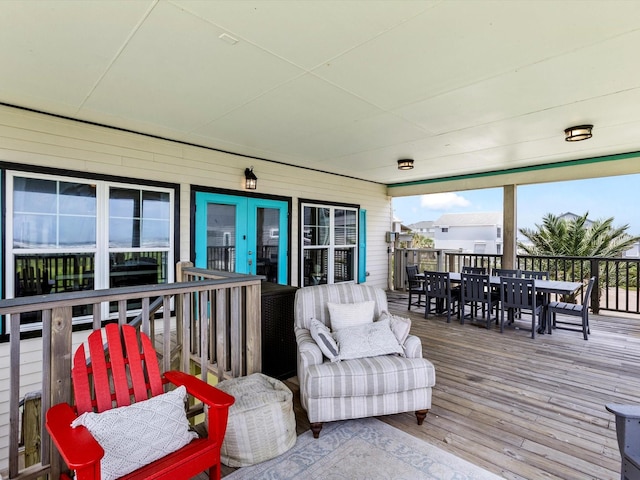 4138 Defender Ln, Galveston, TX 77554 - wooden terrace with outdoor dining space