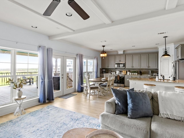 4138 Defender Ln, Galveston, TX 77554 - living room featuring beamed ceiling, ceiling fan, visible vents, light wood-type flooring, and french doors