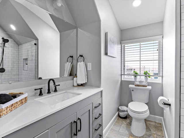 4138 Defender Ln, Galveston, TX 77554 - bathroom featuring tiled shower, vanity, toilet, baseboards, and lofted ceiling