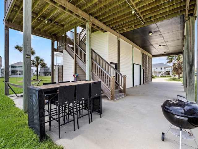 4138 Defender Ln, Galveston, TX 77554 - view of patio / terrace featuring outdoor dry bar, stairs, a residential view, and a grill
