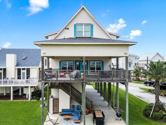 4138 Defender Ln, Galveston, TX 77554 - rear view of house with stairway, a porch, a yard, and roof with shingles