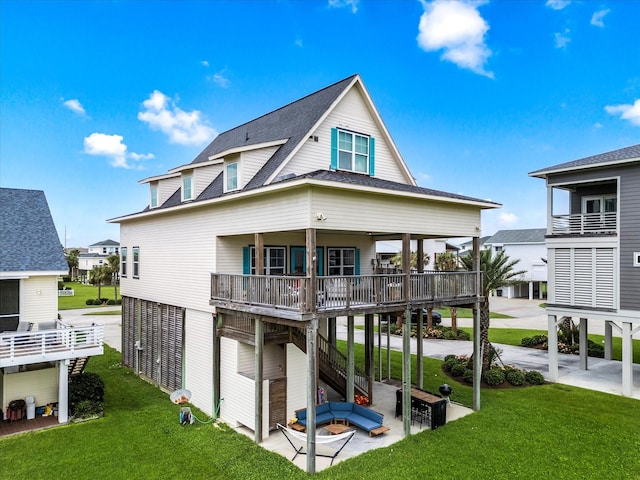 4138 Defender Ln, Galveston, TX 77554 - rear view of house featuring a lawn, stairway, a shingled roof, and a patio area