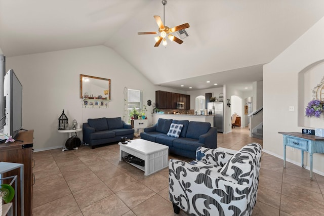 living room featuring ceiling fan, arched walkways, light tile patterned flooring, vaulted ceiling, and stairs