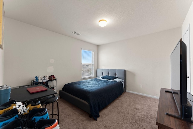 bedroom with visible vents, carpet, and baseboards