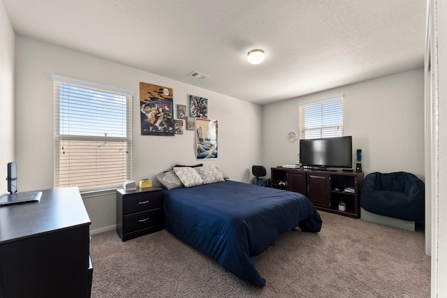 bedroom with visible vents and carpet