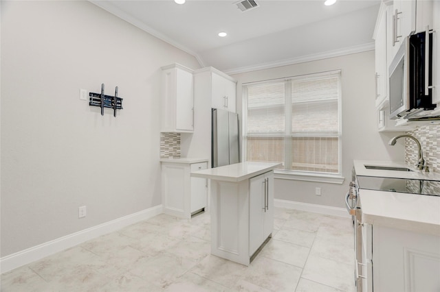 2827 Brisk Autumn Dr, Richmond, TX 77406 - kitchen with a sink, stainless steel appliances, white cabinets, crown molding, and backsplash