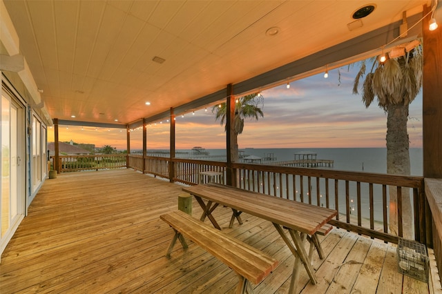 wooden terrace featuring a water view