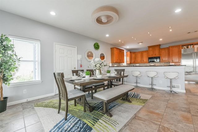 dining room featuring baseboards, visible vents, light tile patterned floors, and recessed lighting