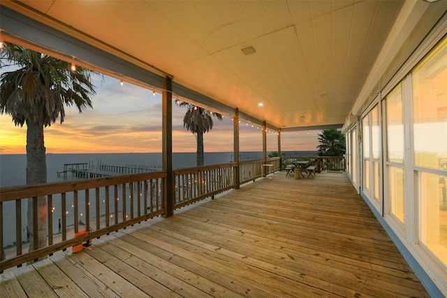wooden terrace featuring a water view