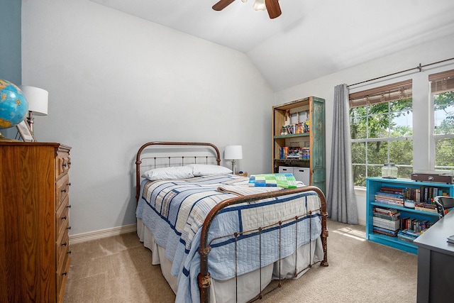 bedroom featuring light colored carpet, ceiling fan, vaulted ceiling, and baseboards