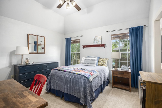bedroom with a ceiling fan, vaulted ceiling, and light colored carpet
