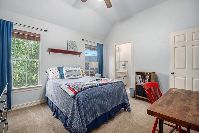 bedroom with carpet, vaulted ceiling, ensuite bathroom, baseboards, and a ceiling fan
