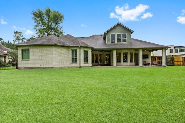5006 Newport Ct, Spring, TX 77386 - back of house featuring a yard, brick siding, a ceiling fan, and fence private yard