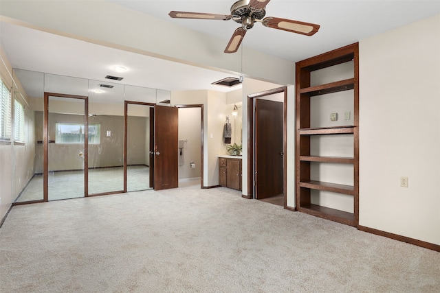 710 Alyse St, Deer Park, TX 77536 - unfurnished bedroom with two closets, carpet, baseboards, visible vents, and a ceiling fan