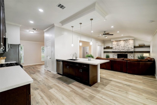 kitchen featuring a sink, ceiling fan, stainless steel appliances, light countertops, and visible vents
