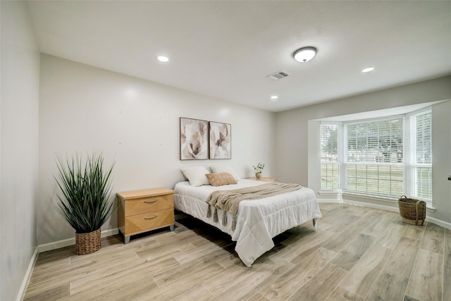 bedroom with visible vents, recessed lighting, light wood finished floors, and baseboards