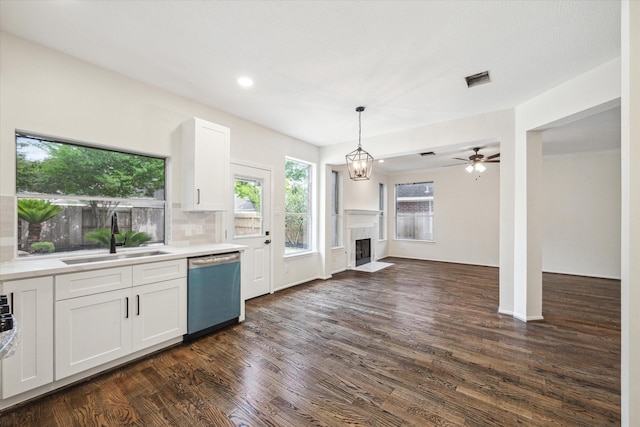 kitchen with a sink, dark wood-style floors, a fireplace with flush hearth, and dishwasher