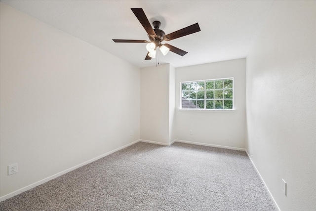 carpeted empty room with a ceiling fan and baseboards