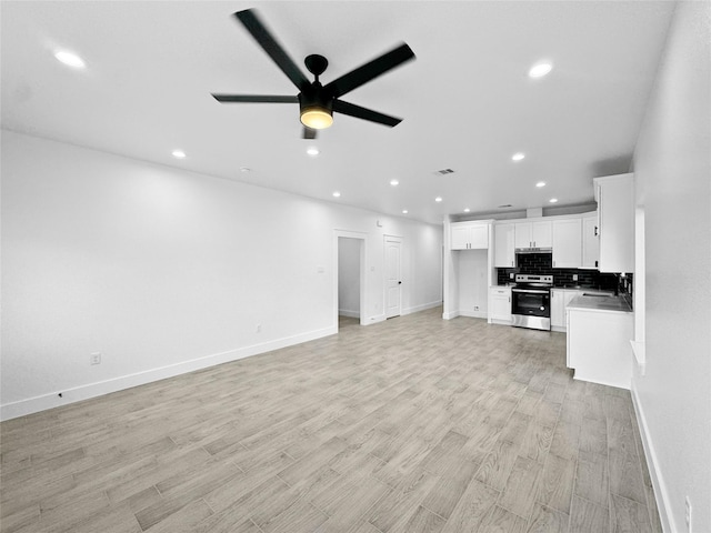 unfurnished living room featuring recessed lighting, ceiling fan, and baseboards