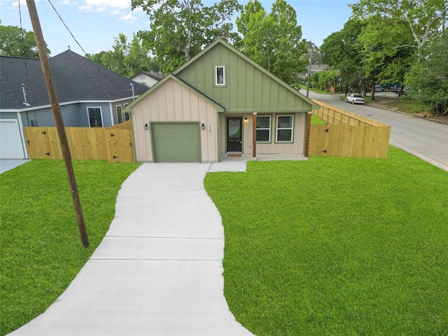 view of front of home with fence, a front lawn, board and batten siding, and concrete driveway