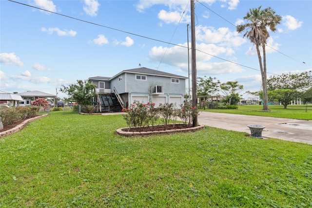 1114 Helen Dowdy Prt, Bolivar, TX 77650 - rear view of house with driveway, an attached garage, stairway, and a yard