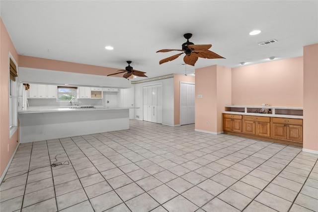 1114 Helen Dowdy Prt, Bolivar, TX 77650 - kitchen featuring light countertops, ceiling fan, a peninsula, baseboards, and open floor plan