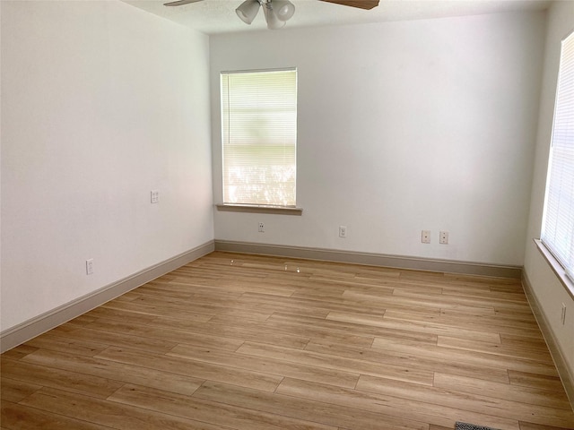 1402 Firwood Cir, Pasadena, TX 77502 - spare room featuring a ceiling fan, light wood finished floors, and baseboards