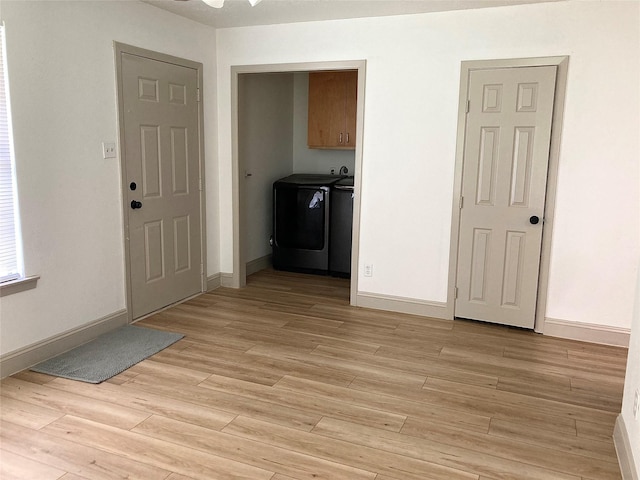 1402 Firwood Cir, Pasadena, TX 77502 - laundry area with washer and dryer, cabinet space, light wood-style flooring, and baseboards
