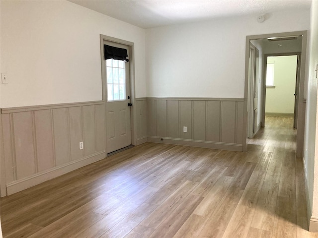 1402 Firwood Cir, Pasadena, TX 77502 - empty room with light wood-style flooring and a wainscoted wall