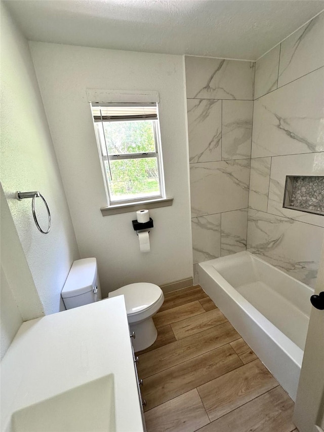 1402 Firwood Cir, Pasadena, TX 77502 - full bathroom with toilet, wood finished floors, and baseboards