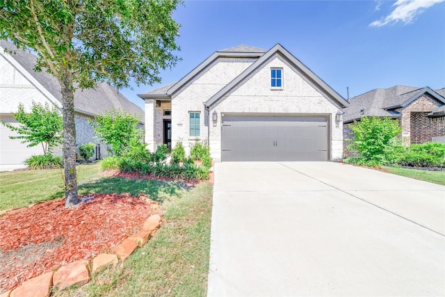 10554 Cecilia Star Ln, Richmond, TX 77406 - french country home with brick siding, concrete driveway, an attached garage, and a front yard