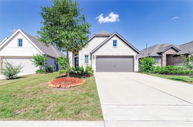 10554 Cecilia Star Ln, Richmond, TX 77406 - french country home with a front yard, driveway, an attached garage, and brick siding
