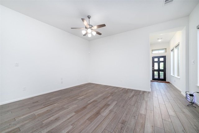 10554 Cecilia Star Ln, Richmond, TX 77406 - empty room featuring wood finished floors, a ceiling fan, and baseboards