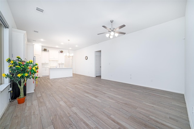 10554 Cecilia Star Ln, Richmond, TX 77406 - unfurnished living room with ceiling fan, a chandelier, light wood-style flooring, baseboards, and recessed lighting