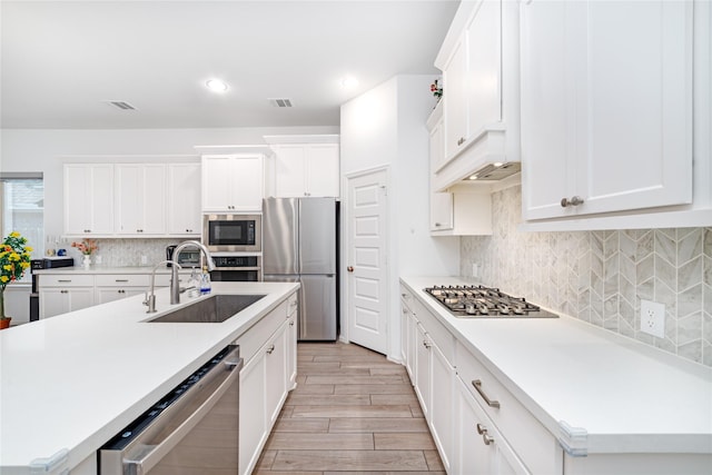 10554 Cecilia Star Ln, Richmond, TX 77406 - kitchen with a sink, appliances with stainless steel finishes, light wood-style flooring, light countertops, and tasteful backsplash