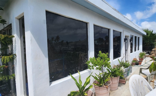 1435 Tiki Dr, Tiki Island, TX 77554 - view of home's exterior featuring stucco siding and a patio