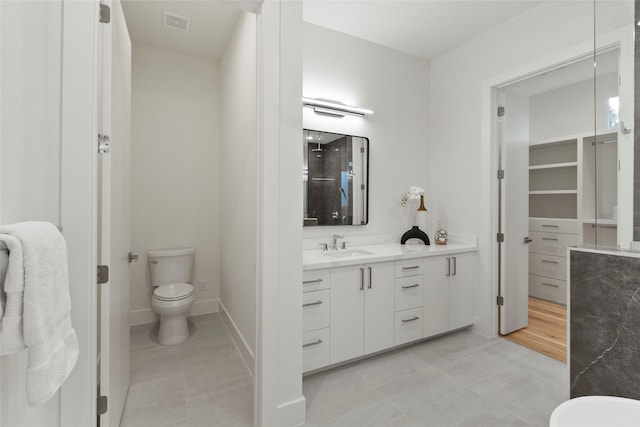 full bath with tile patterned floors, baseboards, toilet, and vanity