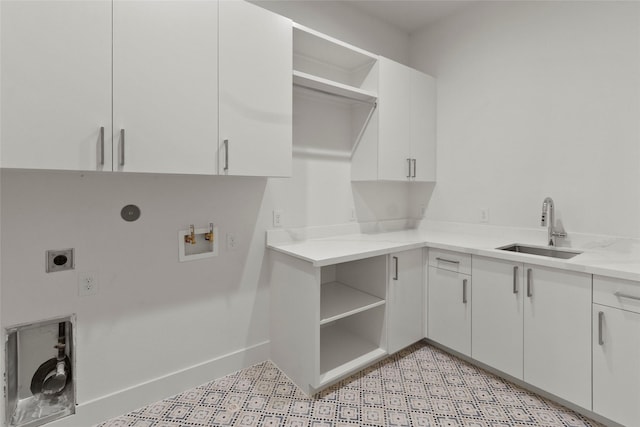 laundry room with hookup for a washing machine, electric dryer hookup, cabinet space, a sink, and baseboards