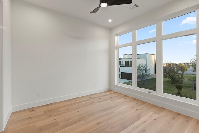 empty room with baseboards, visible vents, light wood-type flooring, and recessed lighting