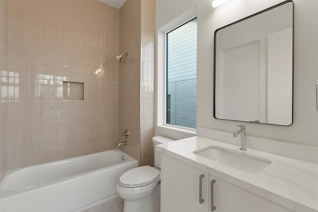 bathroom featuring toilet, shower / bathing tub combination, and vanity