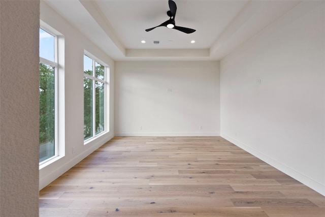spare room with recessed lighting, ceiling fan, visible vents, light wood-style flooring, and baseboards