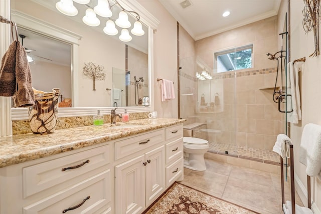 full bath with vanity, tile patterned floors, toilet, a stall shower, and ornamental molding