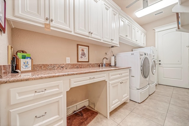 laundry room with cabinet space, a sink, visible vents, light tile patterned flooring, and washer and clothes dryer