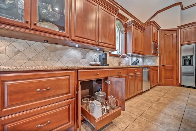 kitchen featuring brown cabinets, built in appliances, light tile patterned floors, light stone counters, and ornamental molding