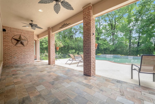 view of patio featuring a ceiling fan and an outdoor pool