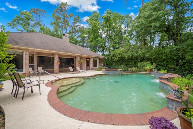 view of pool featuring a pool with connected hot tub and a patio area