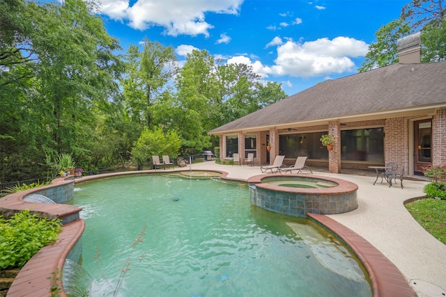 view of pool with a patio area and a pool with connected hot tub