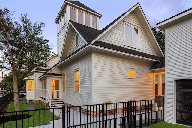 1343 Allston St, Houston, TX 77008 - view of side of property featuring a yard, a fenced front yard, and roof with shingles